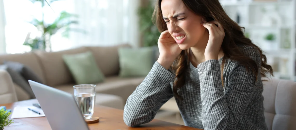 person touching jaw discomfort