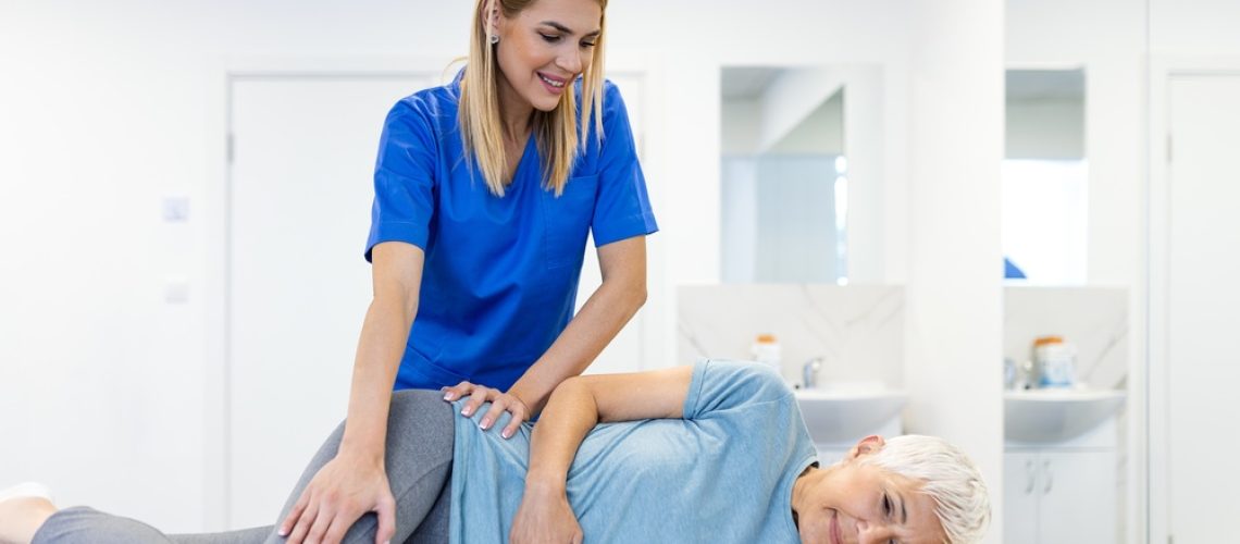 Professional,Female,Therapist,Performing,Manual,Hip,Therapy,On,A,Senior